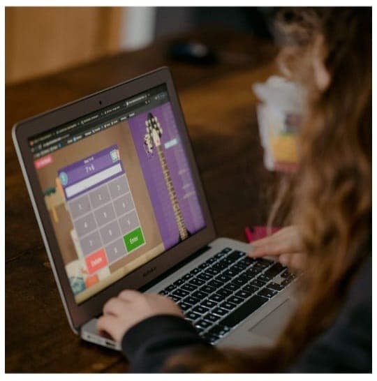 Child learning interactively through an educational laptop game